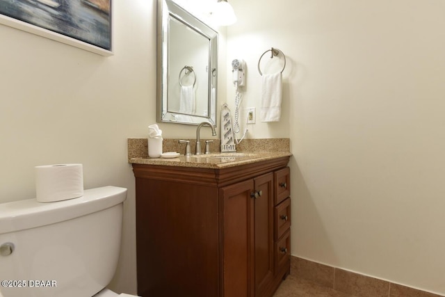 bathroom featuring toilet, vanity, and tile patterned floors