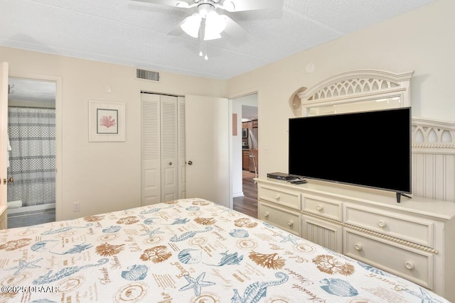 bedroom featuring a closet, a ceiling fan, and a textured ceiling