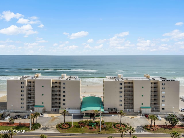 birds eye view of property with a view of the beach and a water view