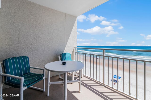 balcony with a view of the beach and a water view