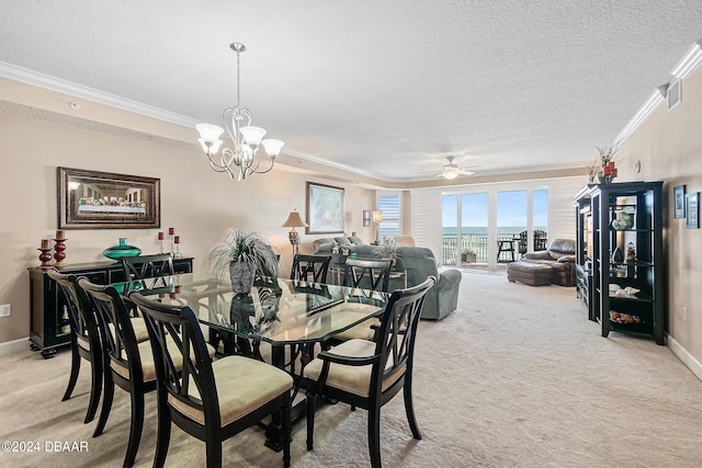 dining room with light colored carpet, ceiling fan with notable chandelier, a textured ceiling, and crown molding