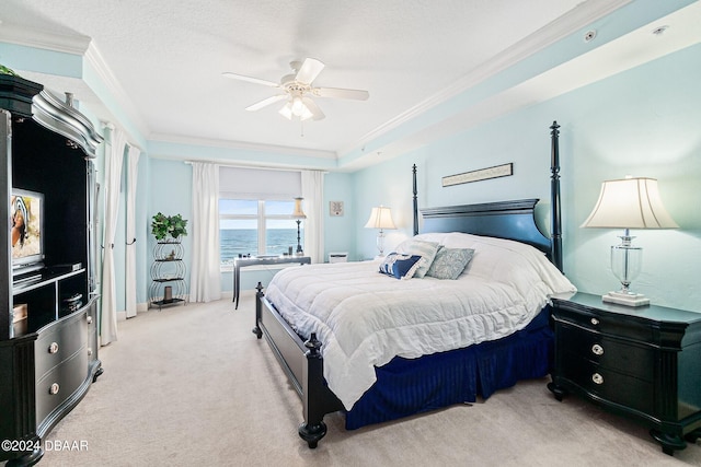 carpeted bedroom featuring ornamental molding, a water view, and ceiling fan