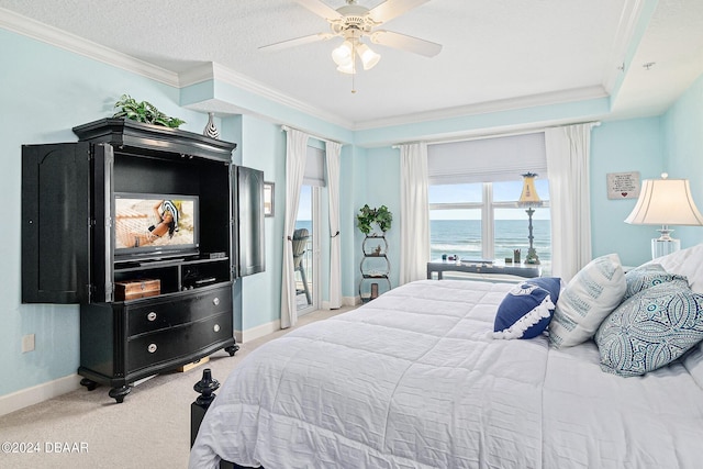 bedroom featuring ceiling fan, light colored carpet, a textured ceiling, and crown molding