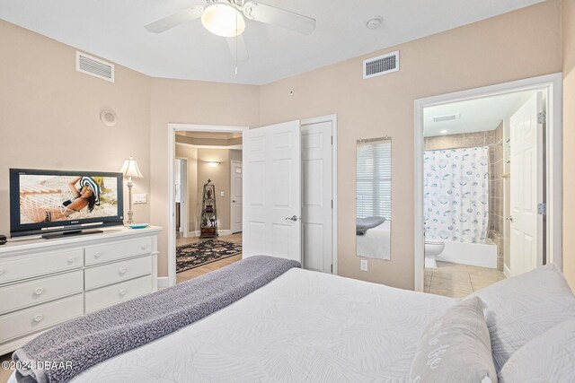 bedroom featuring ceiling fan, connected bathroom, and light tile patterned floors