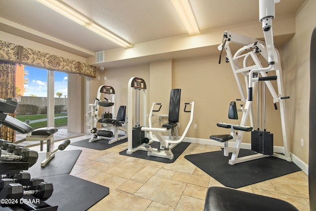 exercise room featuring a textured ceiling