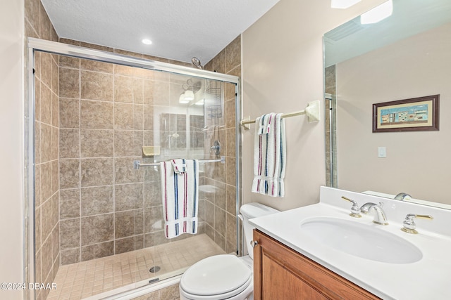 bathroom featuring toilet, an enclosed shower, vanity, and a textured ceiling