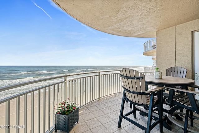 balcony with a beach view and a water view