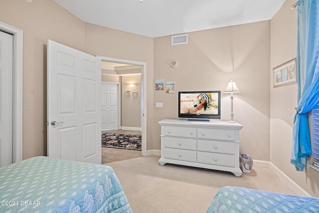 bedroom featuring light colored carpet