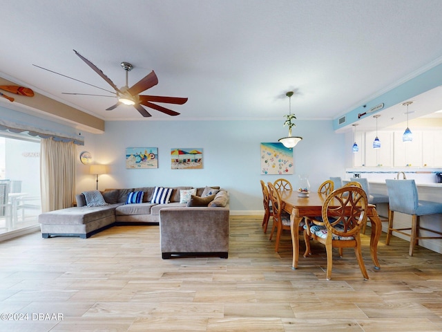 living room featuring light hardwood / wood-style flooring, ceiling fan, and crown molding