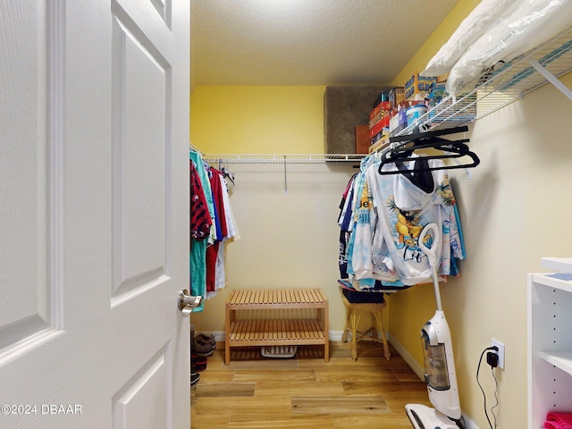 walk in closet featuring light hardwood / wood-style floors