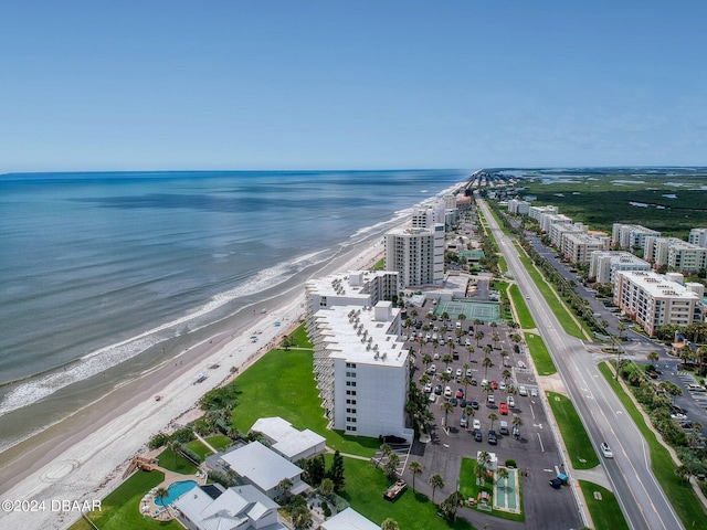 birds eye view of property with a water view and a beach view