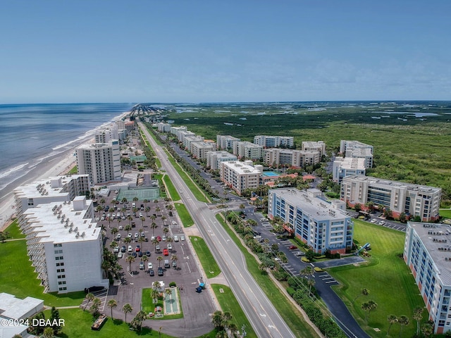 birds eye view of property with a beach view and a water view