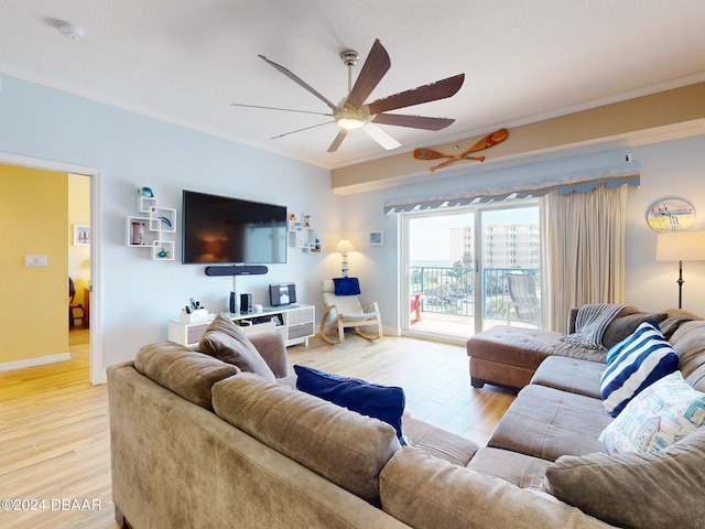 living room featuring ornamental molding, hardwood / wood-style flooring, and ceiling fan