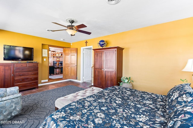 tiled bedroom featuring ceiling fan