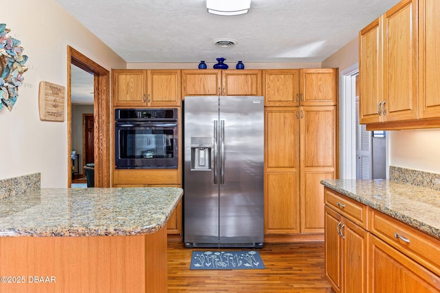 kitchen featuring stainless steel fridge with ice dispenser, oven, hardwood / wood-style flooring, kitchen peninsula, and light stone countertops