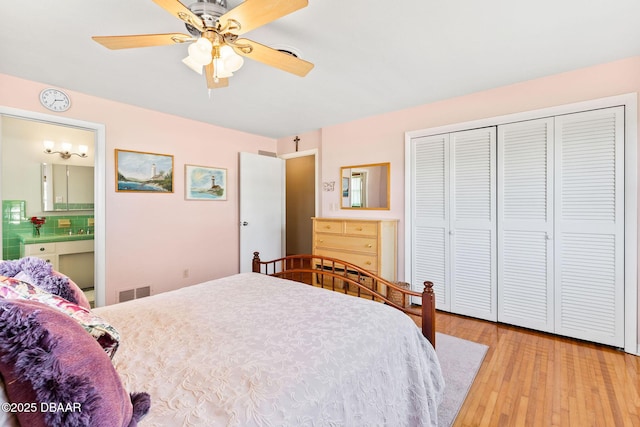 bedroom with ceiling fan, ensuite bath, a closet, and light wood-type flooring