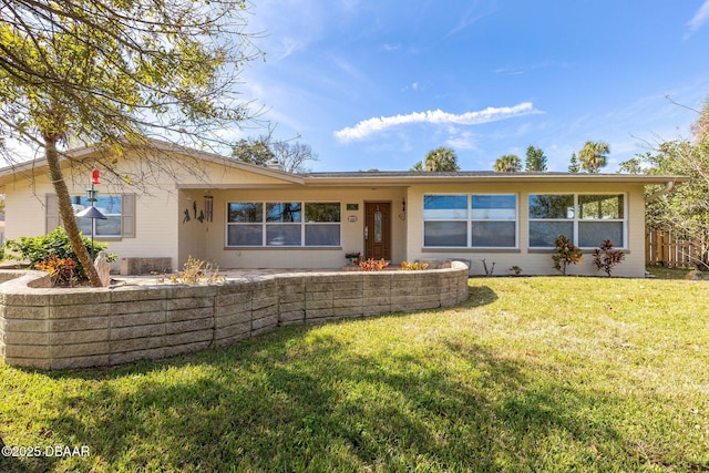 back of property featuring a lawn