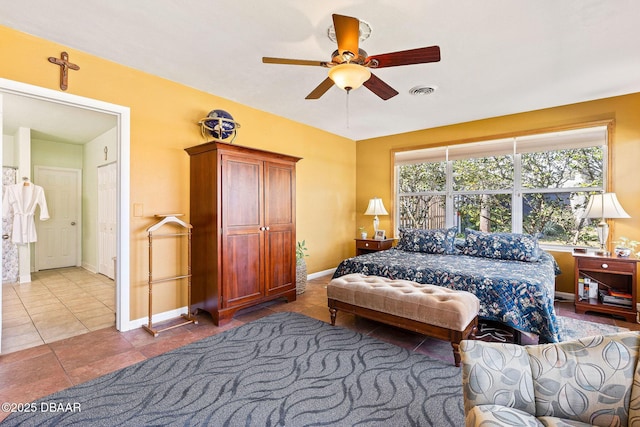 tiled bedroom featuring ceiling fan