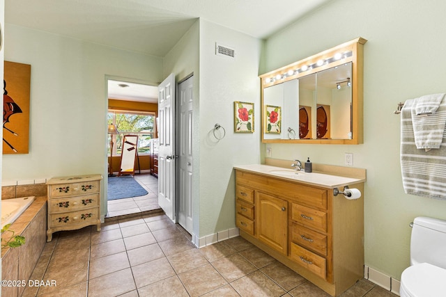 bathroom with tile patterned floors, vanity, and toilet