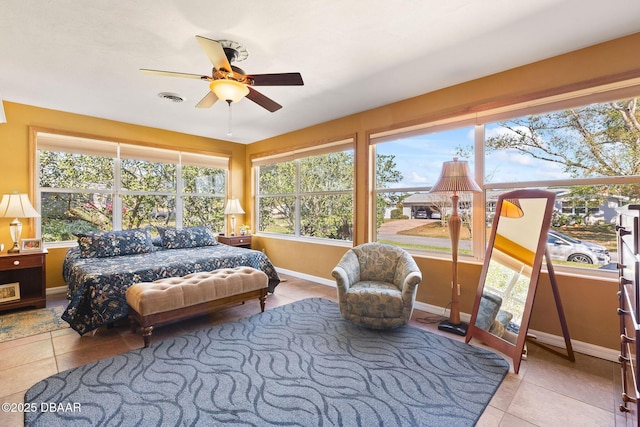 tiled bedroom with ceiling fan