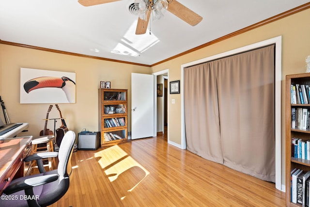 office area with crown molding, ceiling fan, and light hardwood / wood-style floors