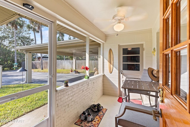 sunroom featuring ceiling fan