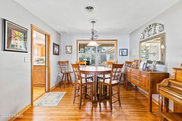 dining room featuring plenty of natural light and light hardwood / wood-style flooring