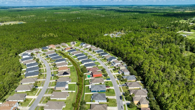 aerial view featuring a residential view and a wooded view