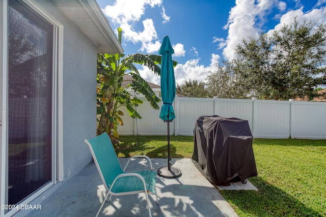 view of patio / terrace featuring a fenced backyard and a grill