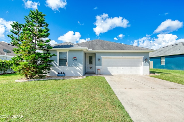 single story home featuring a garage and a front yard