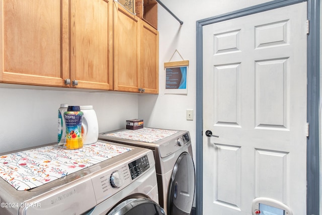 laundry area featuring washer and clothes dryer and cabinet space