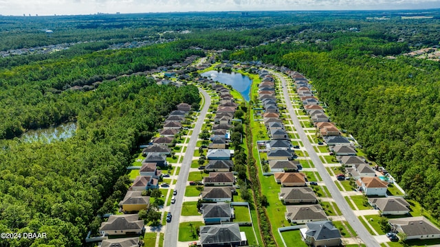 birds eye view of property with a water view, a wooded view, and a residential view