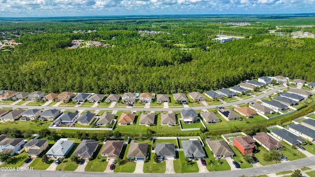 drone / aerial view with a residential view and a wooded view