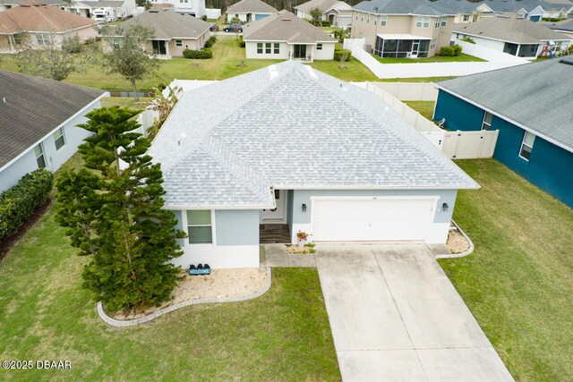 ranch-style home with a garage and a front lawn