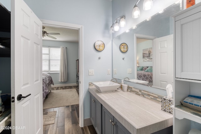 bathroom featuring hardwood / wood-style floors, vanity, and ceiling fan