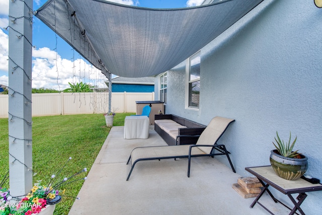 view of patio / terrace with a fenced backyard and a jacuzzi