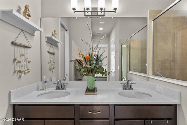 bathroom featuring an enclosed shower and vanity