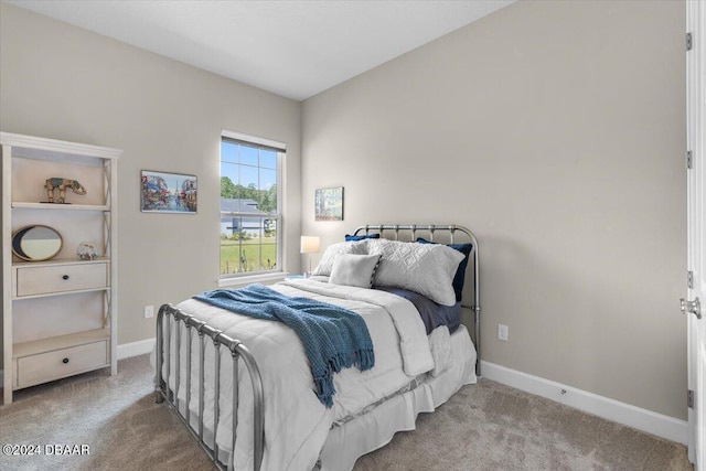 bedroom featuring light colored carpet