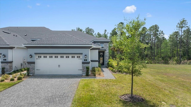 view of front of property featuring a front yard and a garage