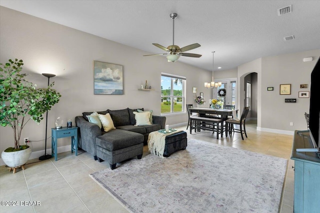 living room featuring ceiling fan with notable chandelier and light tile patterned flooring