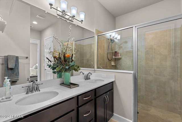 bathroom with a shower with door and vanity