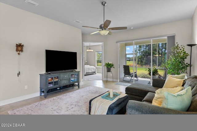 tiled living room with ceiling fan