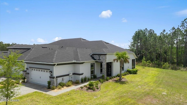 view of front facade with a front yard and a garage