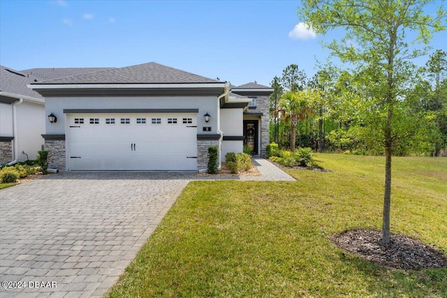 view of front facade with a front yard and a garage