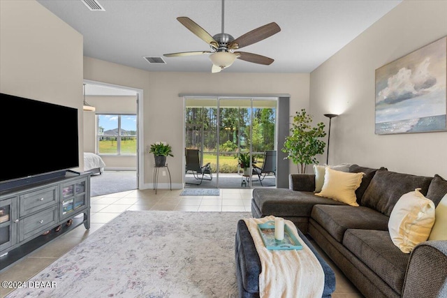 living room featuring light tile patterned flooring and ceiling fan