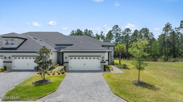 view of front of property with a front lawn and a garage