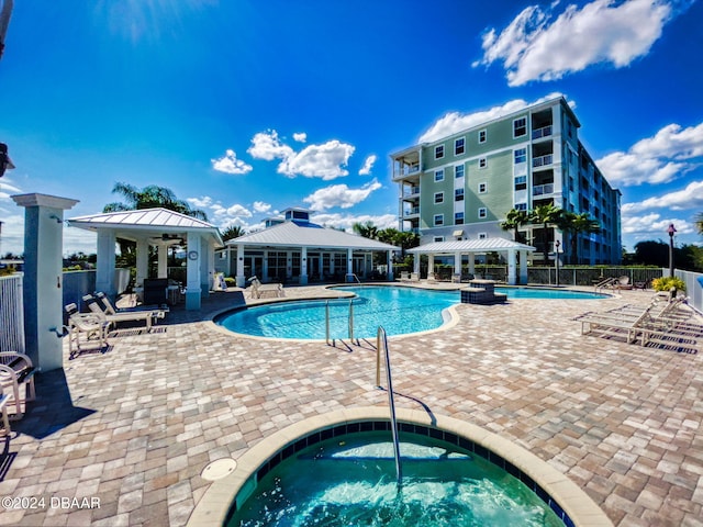 view of pool featuring a community hot tub, a patio, and a gazebo