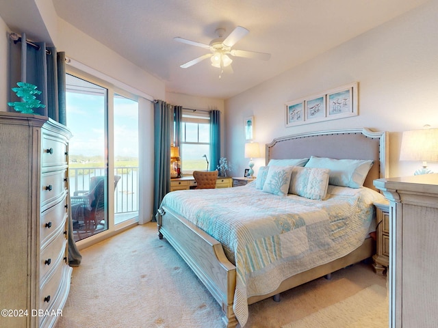 bedroom with access to outside, light colored carpet, and ceiling fan