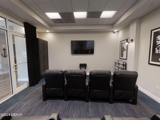 home theater with a paneled ceiling and carpet flooring