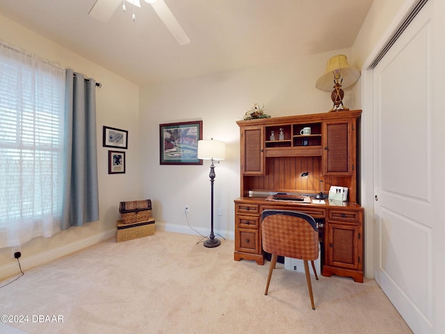 carpeted home office featuring ceiling fan